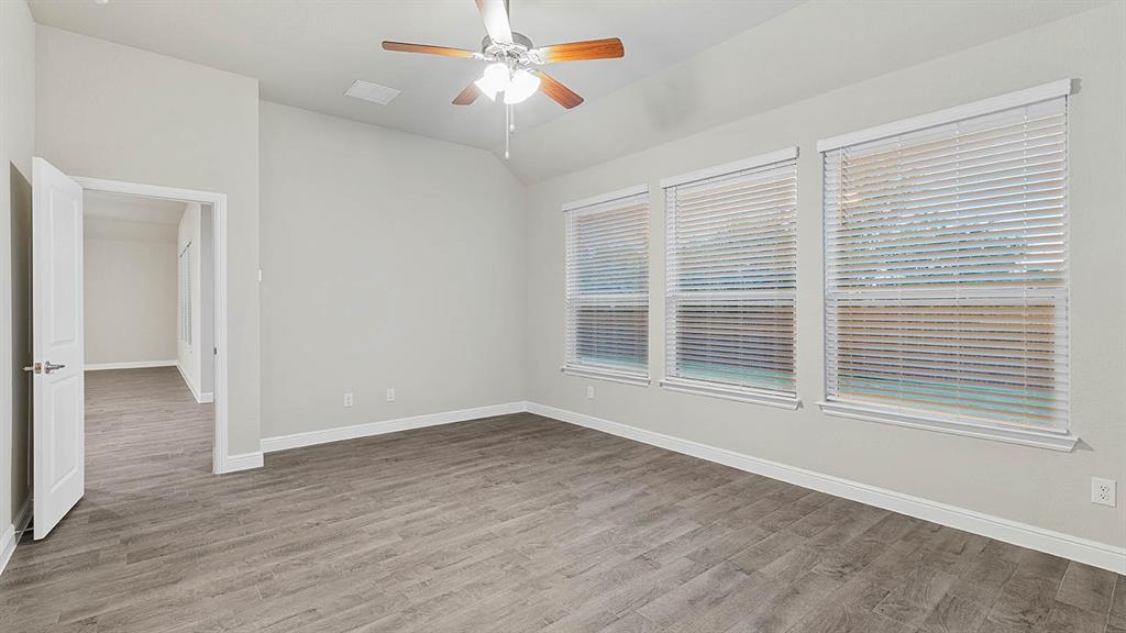 3275 Grayton Street Grand Prairie, TX 76065 - Photo 15 of 36 a view of an empty room with wooden floor and a window
