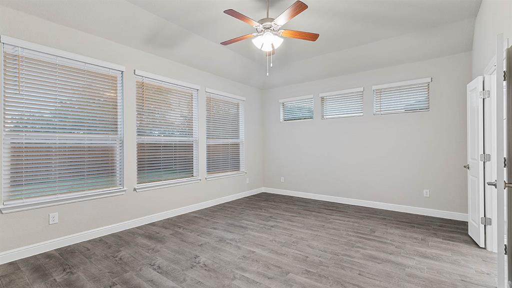 3275 Grayton Street Grand Prairie, TX 76065 - Photo 18 of 36 a view of an empty room with a window and wooden floor