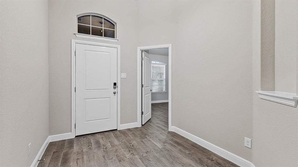 3275 Grayton Street Grand Prairie, TX 76065 - Photo 1 of 36 an empty room with wooden floor and windows