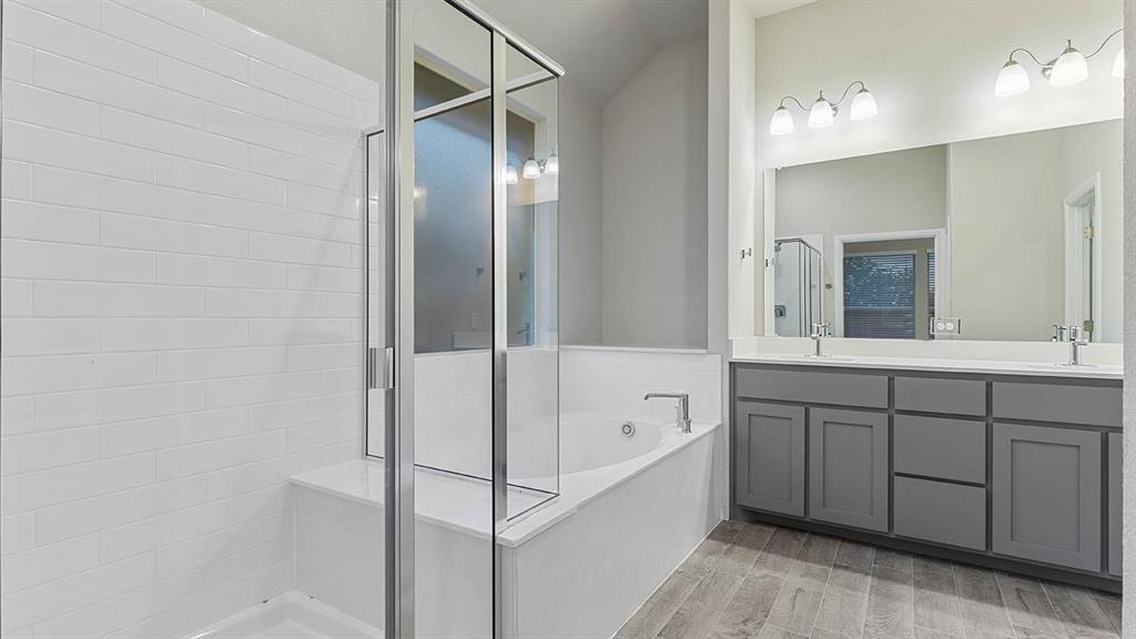 3275 Grayton Street Grand Prairie, TX 76065 - Photo 19 of 36 a spacious bathroom with a tub shower and sink