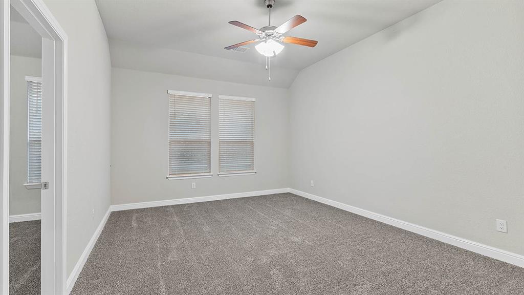 3275 Grayton Street Grand Prairie, TX 76065 - Photo 22 of 36 an empty room with a window and a fan