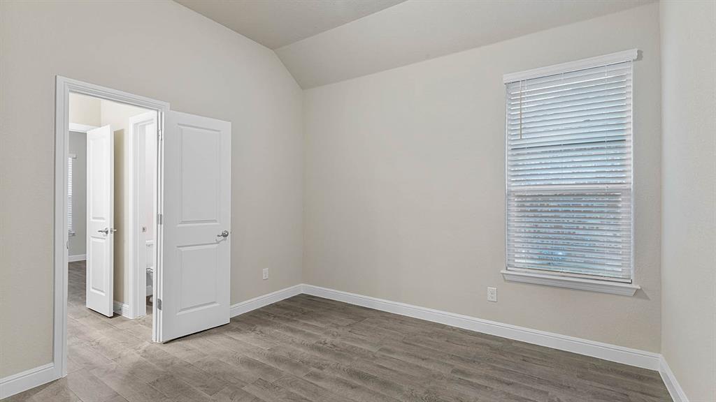 3275 Grayton Street Grand Prairie, TX 76065 - Photo 27 of 36 an empty room with wooden floor and windows