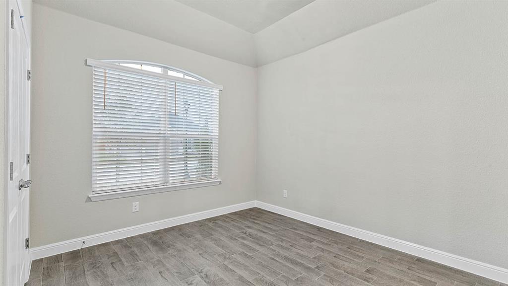3275 Grayton Street Grand Prairie, TX 76065 - Photo 30 of 36 an empty room with wooden floor and a window