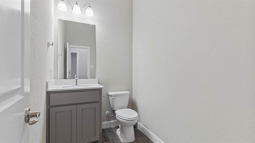 3275 Grayton Street Grand Prairie, TX 76065 - Photo 32 of 36 a bathroom with a toilet sink and mirror
