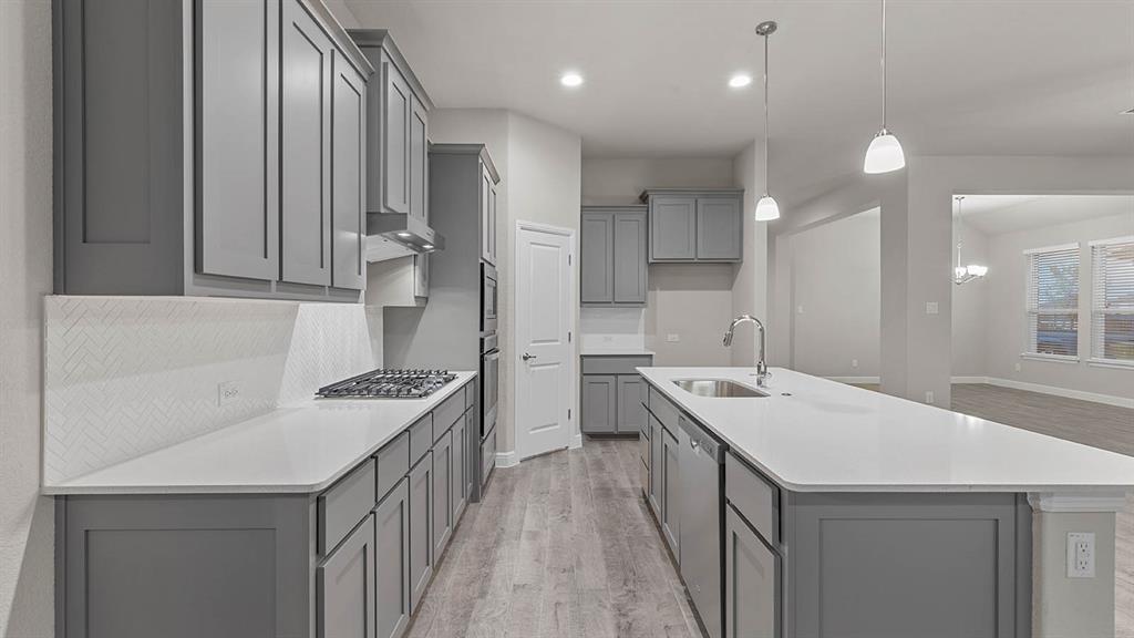 3275 Grayton Street Grand Prairie, TX 76065 - Photo 4 of 36 a kitchen with a sink stove and cabinets