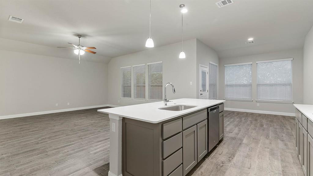 3275 Grayton Street Grand Prairie, TX 76065 - Photo 6 of 36 a kitchen with a sink and a stove top oven