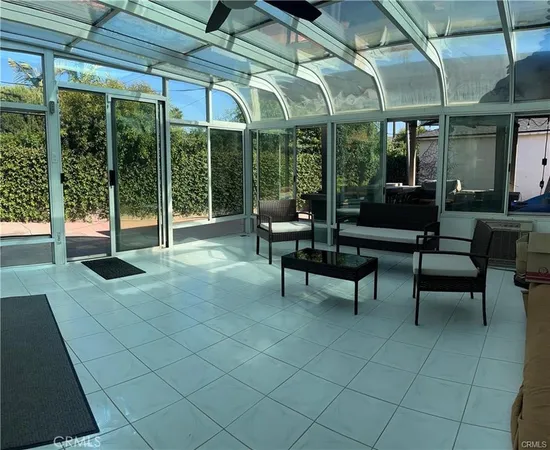 a view of a patio with table and chairs under an umbrella