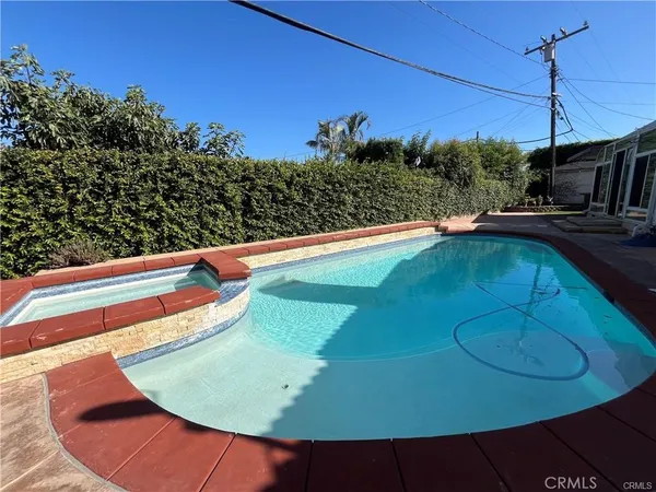 a view of a swimming pool with a yard