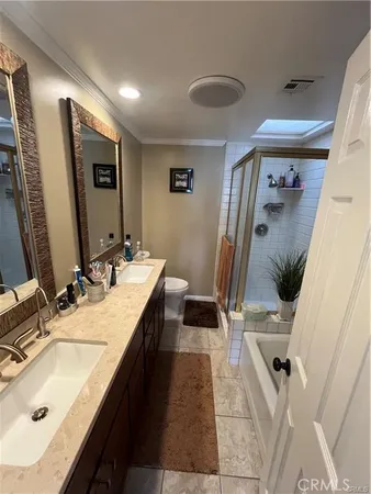 a bathroom with double vanity sink and mirror