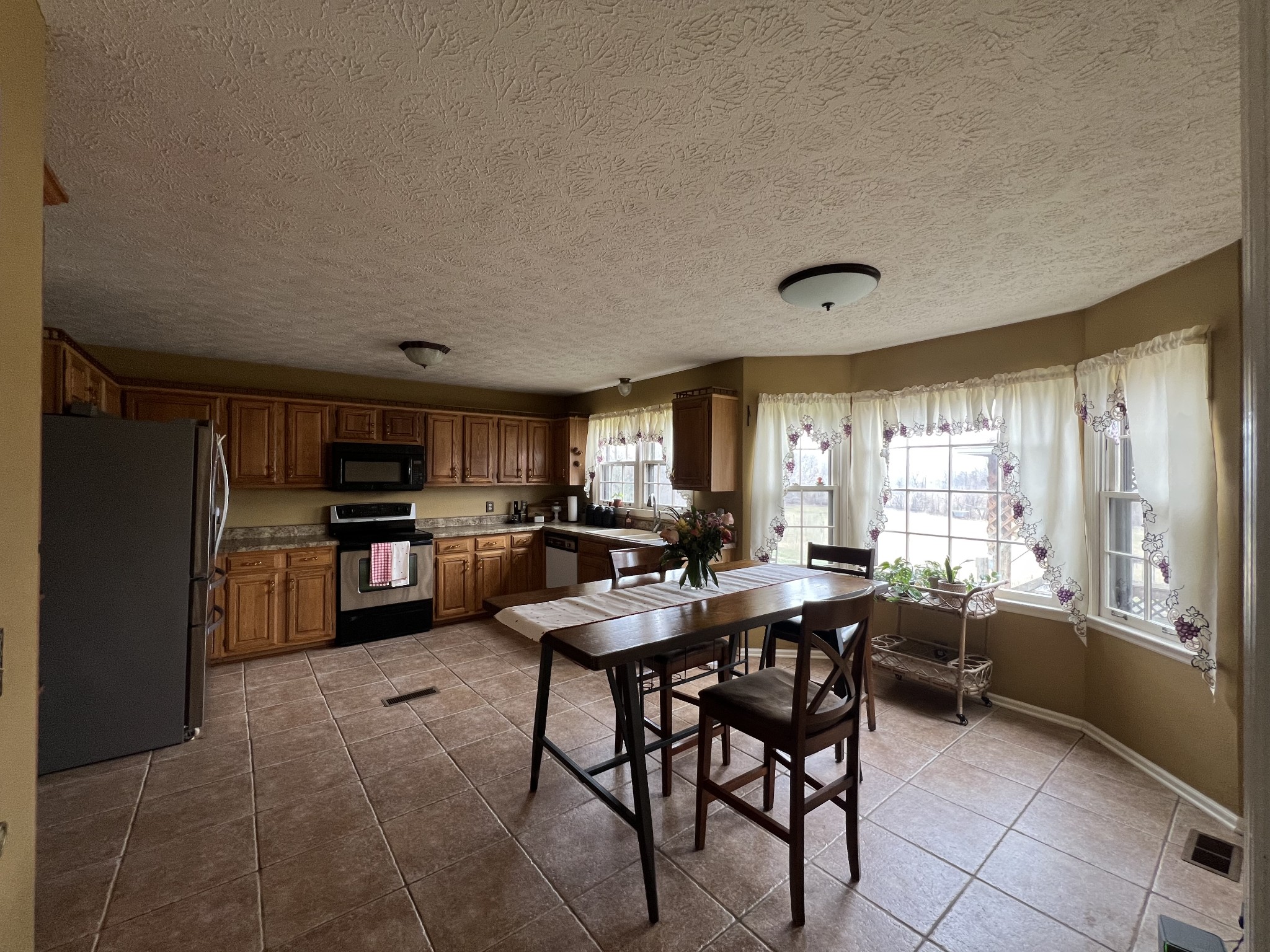 141 Buntin Mill Road Portland, TN 37148 - Photo 16 of 45 a view of a dining room with furniture and a kitchen