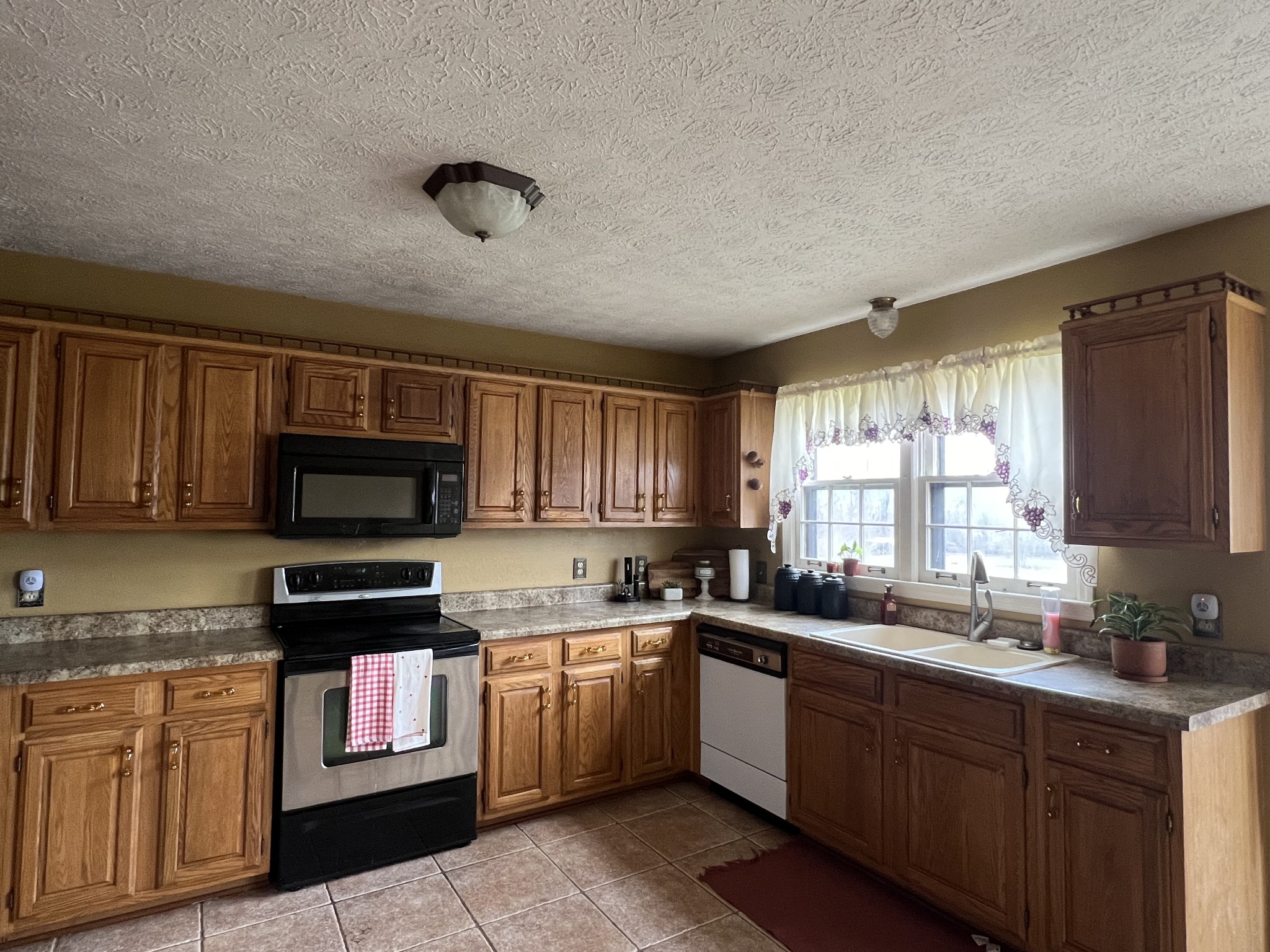 141 Buntin Mill Road Portland, TN 37148 - Photo 18 of 45 a kitchen with granite countertop a sink stainless steel appliances and cabinets