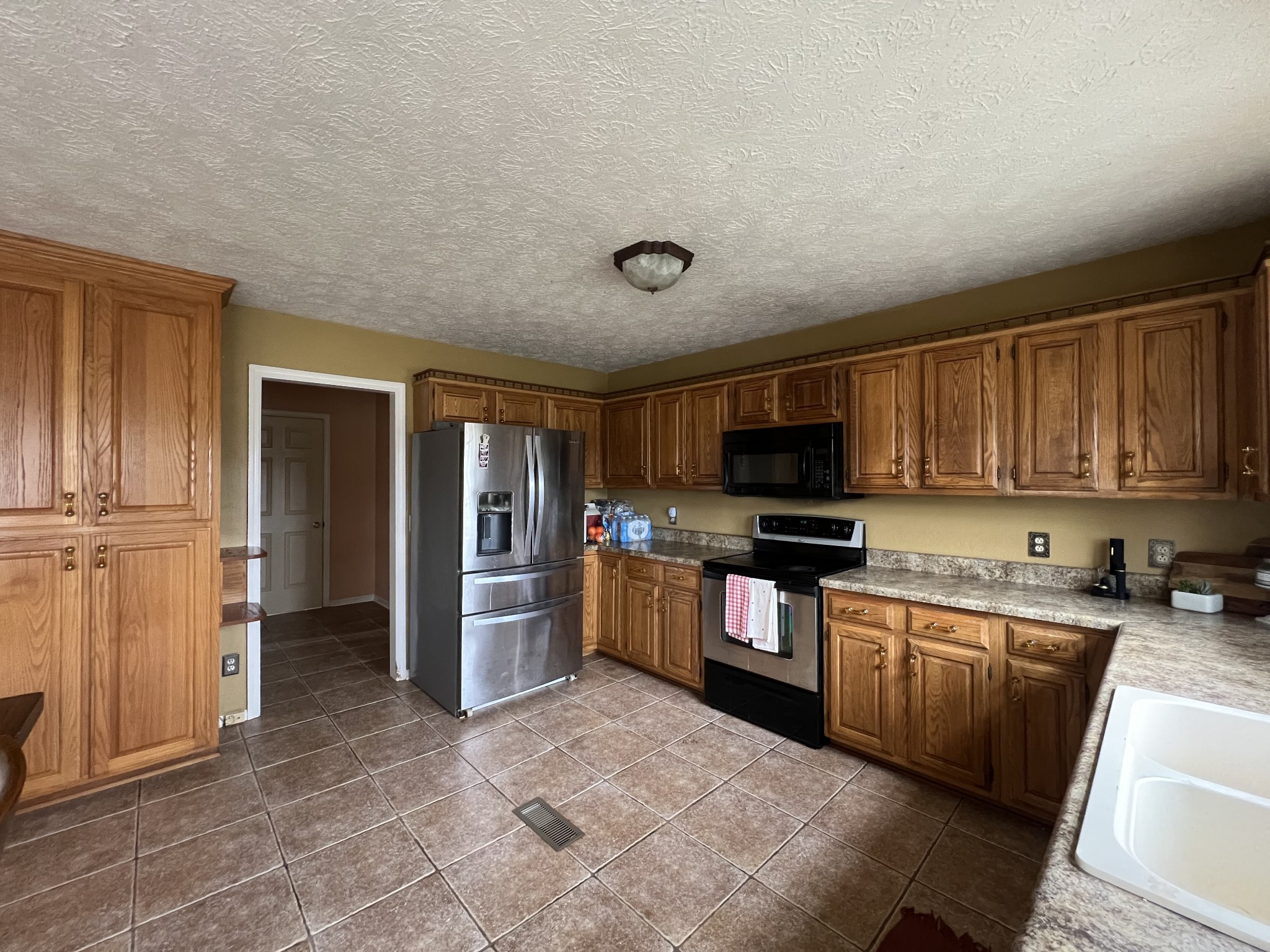 141 Buntin Mill Road Portland, TN 37148 - Photo 19 of 45 a kitchen with stainless steel appliances granite countertop a refrigerator and a stove top oven