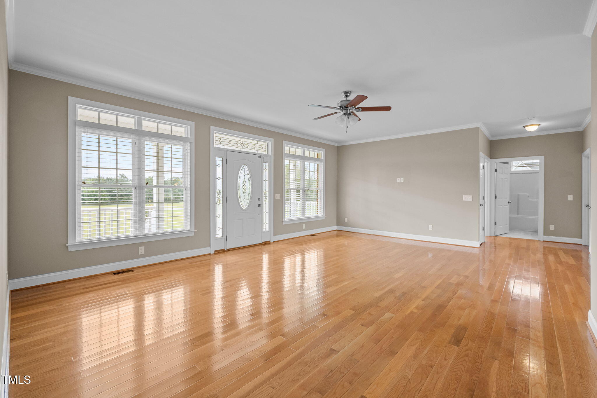 5556 Hurdle Mills Road Roxboro, NC 27574 - Photo 14 of 53 a view of an empty room with wooden floor and a window