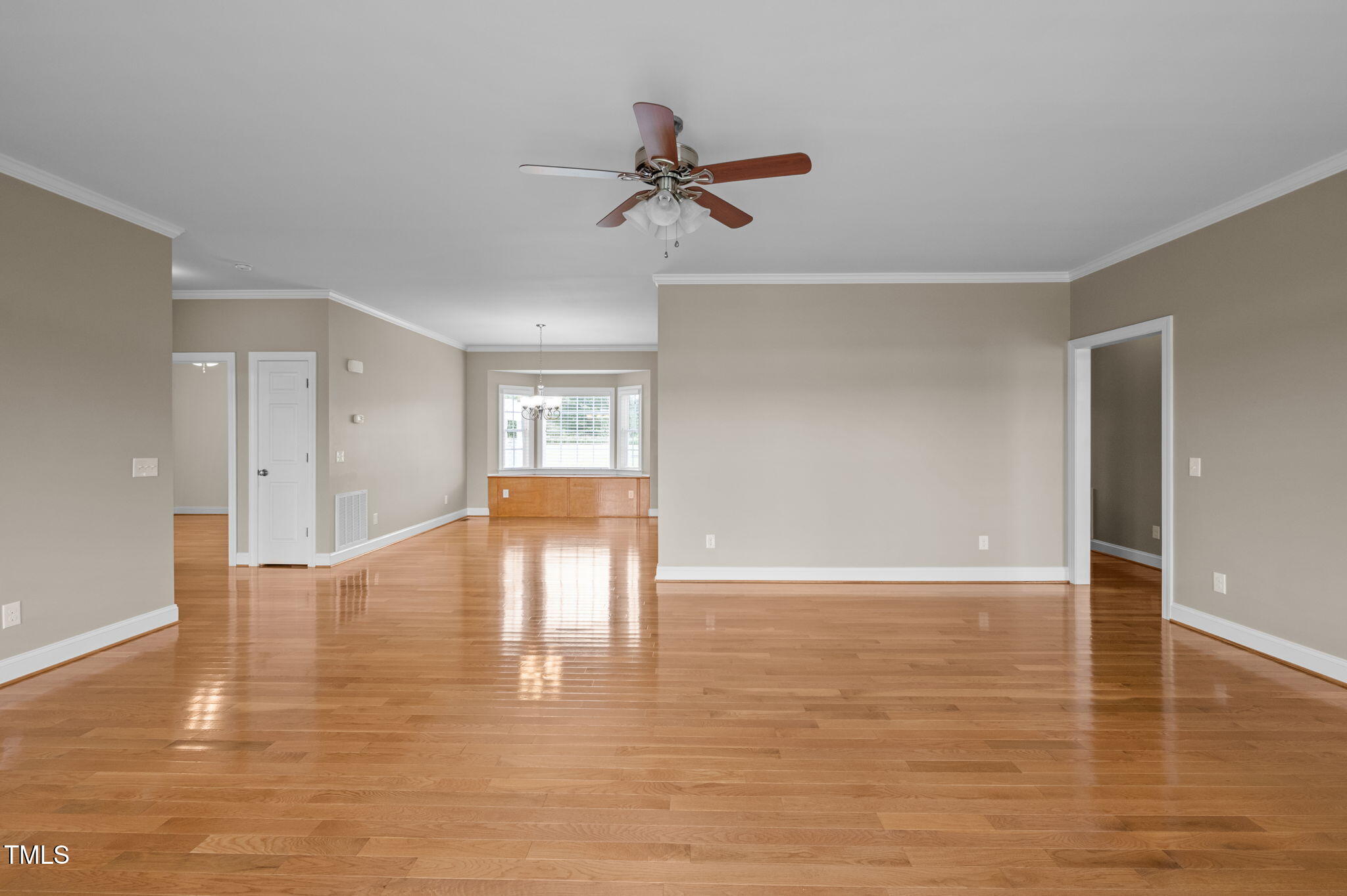 5556 Hurdle Mills Road Roxboro, NC 27574 - Photo 16 of 53 a view of empty room with wooden floor and fan