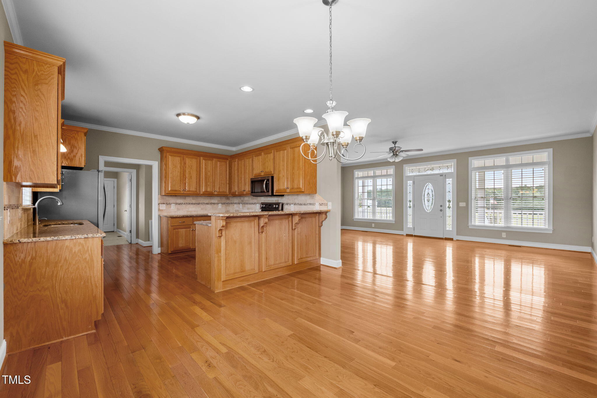 5556 Hurdle Mills Road Roxboro, NC 27574 - Photo 18 of 53 a large kitchen with kitchen island a large counter top space a sink stainless steel appliances and cabinets