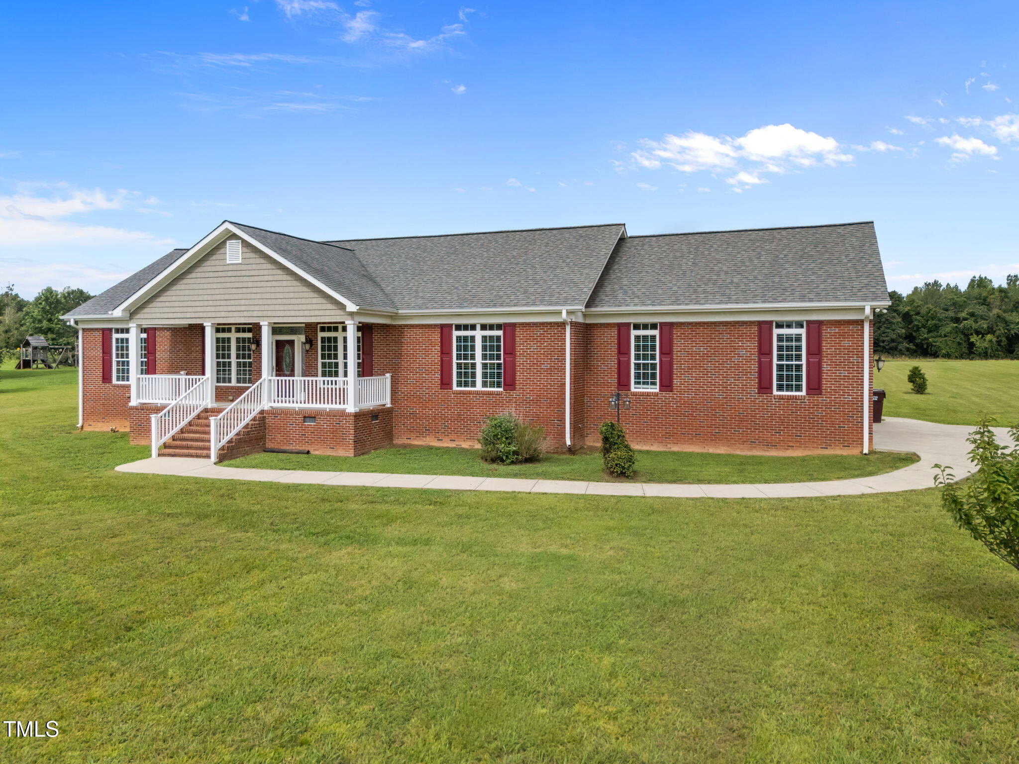 5556 Hurdle Mills Road Roxboro, NC 27574 - Photo 2 of 53 a front view of a house with a garden