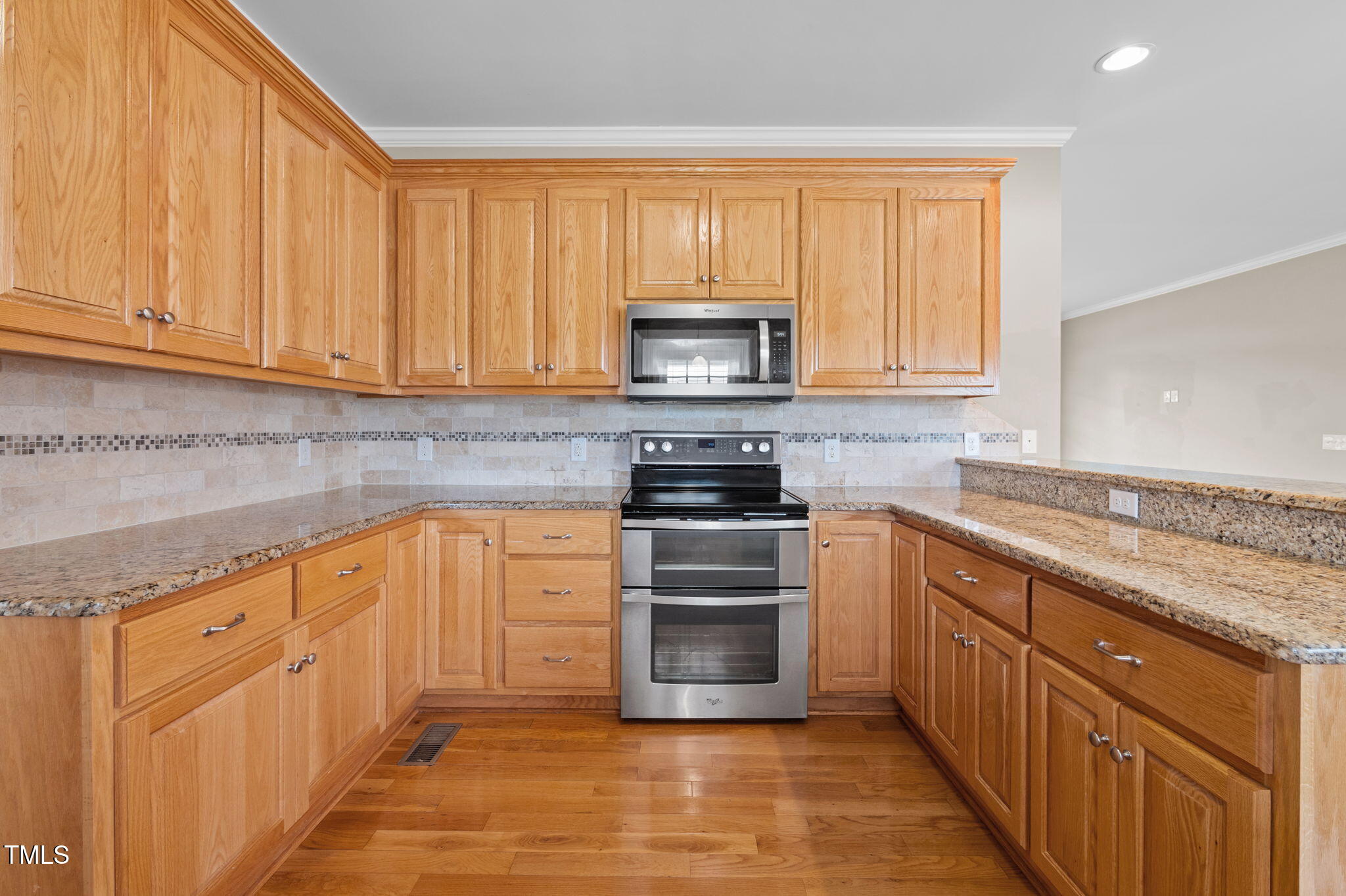 5556 Hurdle Mills Road Roxboro, NC 27574 - Photo 21 of 53 a kitchen with stainless steel appliances granite countertop a stove a sink and a microwave