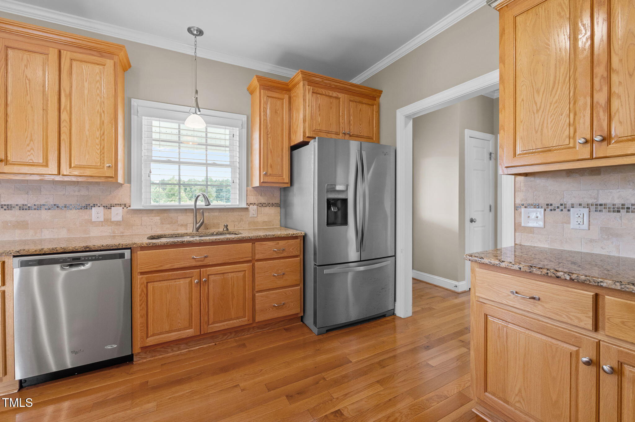 5556 Hurdle Mills Road Roxboro, NC 27574 - Photo 22 of 53 a kitchen with granite countertop cabinets stainless steel appliances and a window