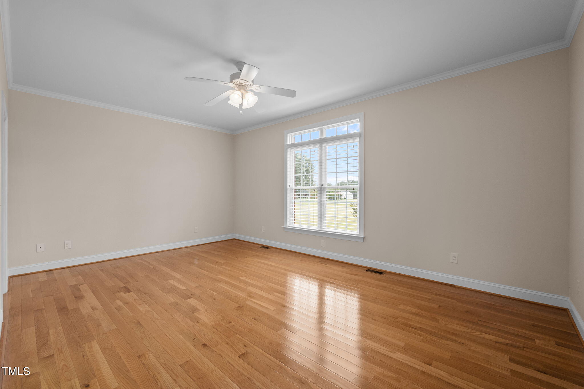 5556 Hurdle Mills Road Roxboro, NC 27574 - Photo 24 of 53 a view of an empty room with wooden floor and a window