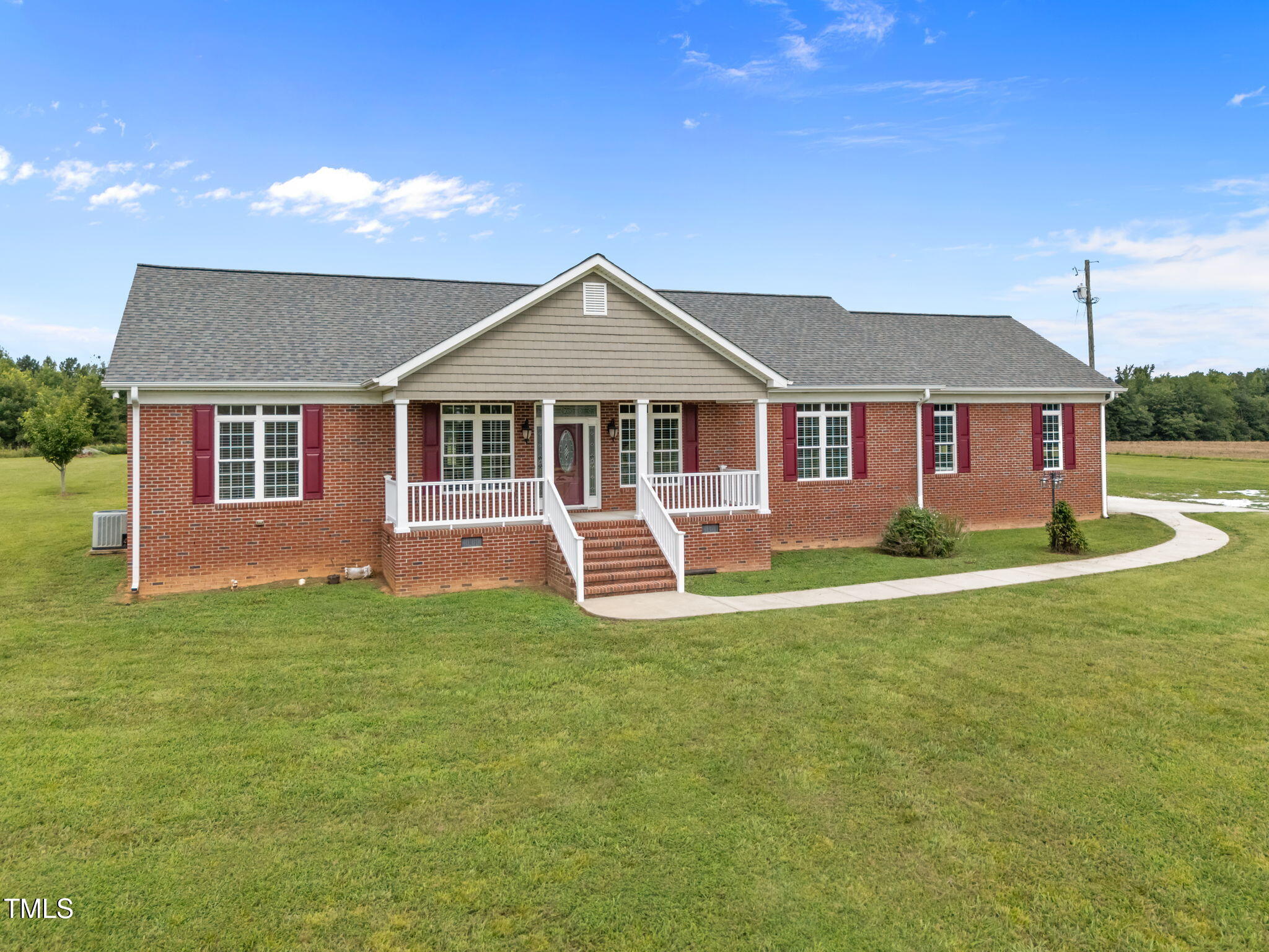 5556 Hurdle Mills Road Roxboro, NC 27574 - Photo 3 of 53 a front view of a house with a garden and yard