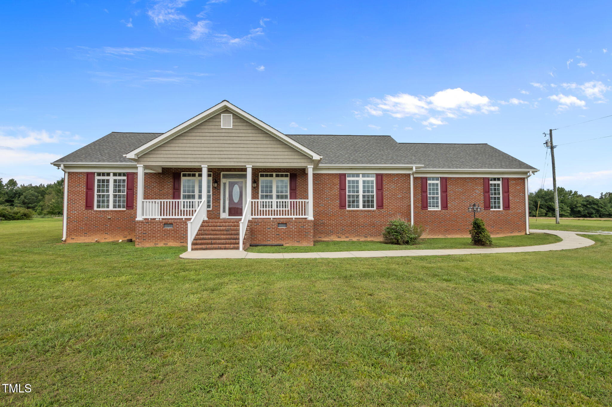 5556 Hurdle Mills Road Roxboro, NC 27574 - Photo 41 of 53 a front view of a house with a garden and yard