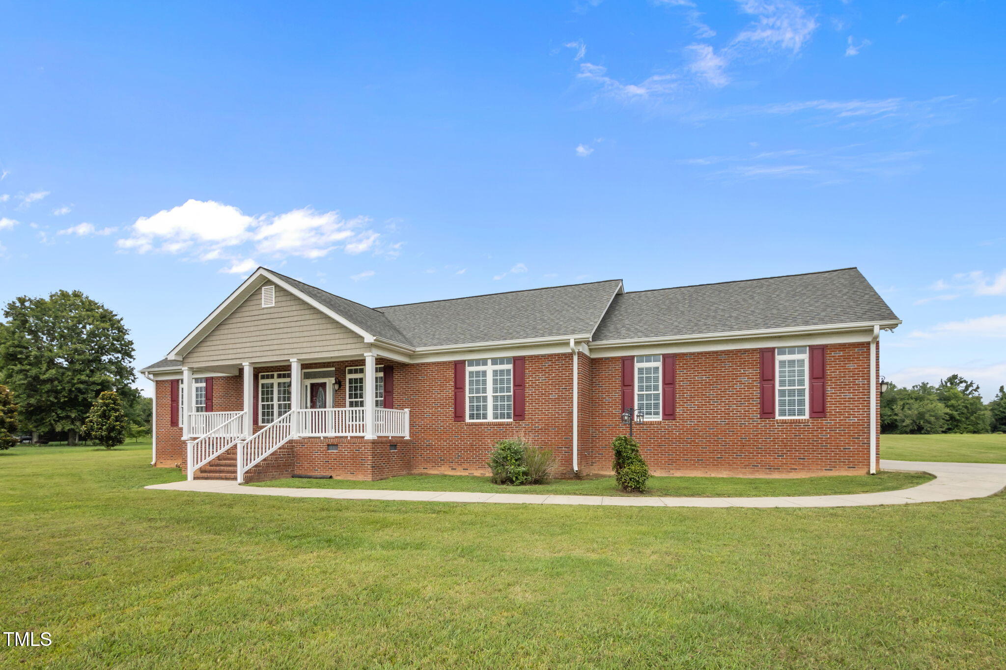 5556 Hurdle Mills Road Roxboro, NC 27574 - Photo 42 of 53 a front view of a house with a garden and plants