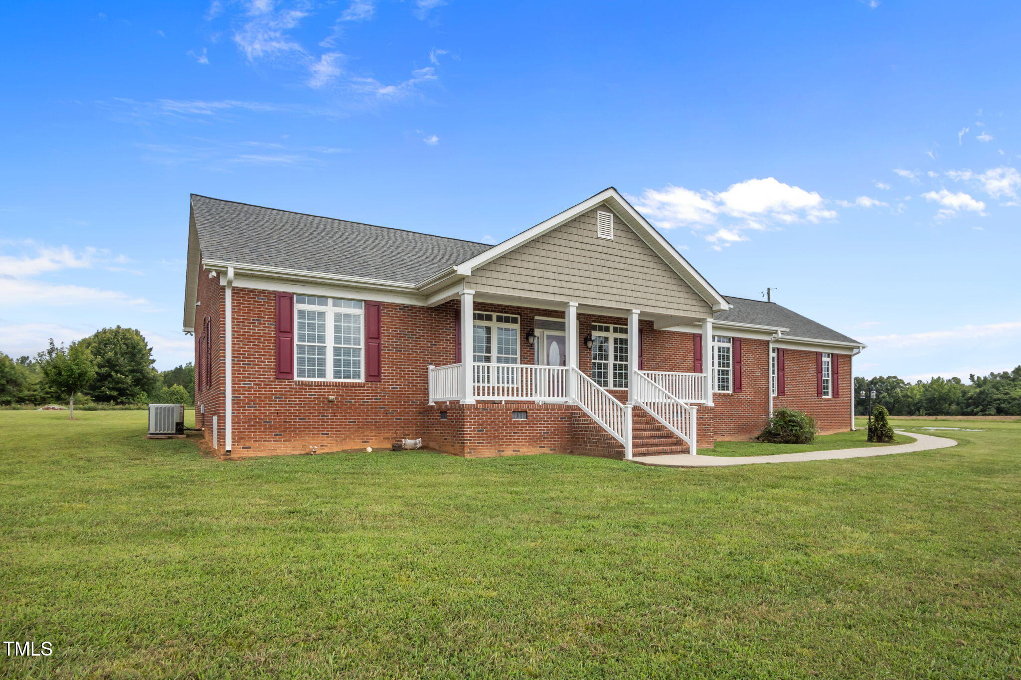 5556 Hurdle Mills Road Roxboro, NC 27574 - Photo 43 of 53 a front view of a house with a yard and porch