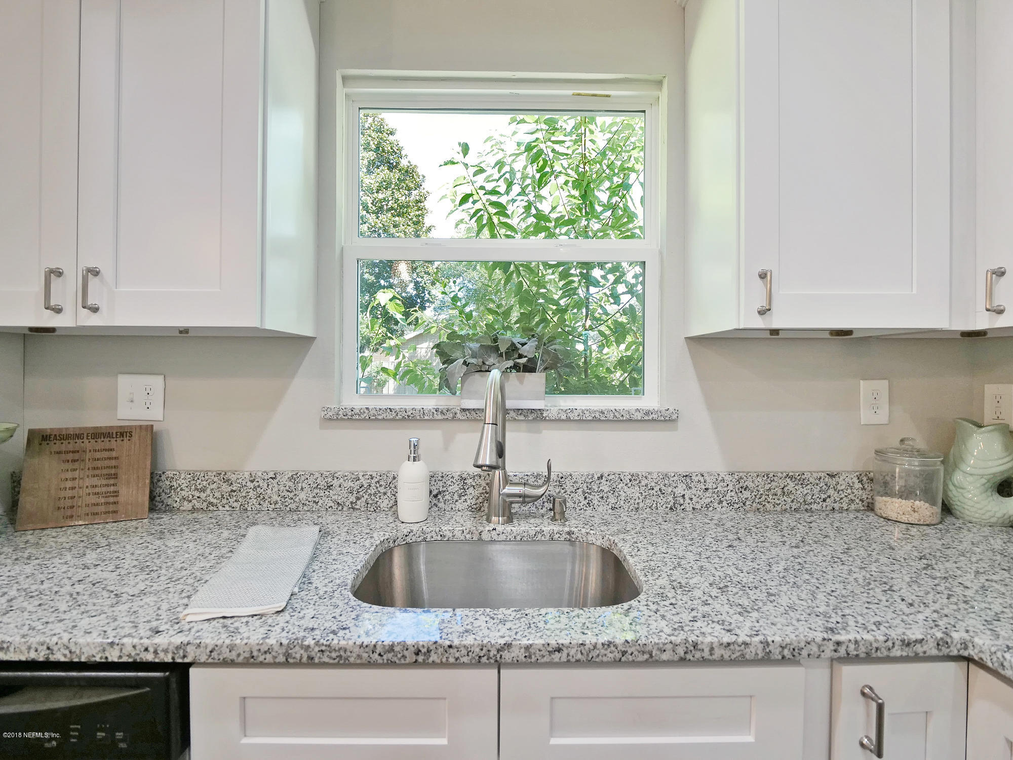 10475 Tulsa Road Jacksonville, FL 32218 - Photo 4 of 30 a kitchen with granite countertop a sink window and cabinets