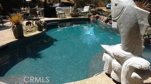 a view of swimming pool outdoor seating area and lake view