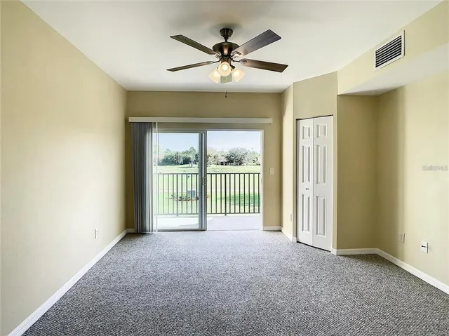 a view of a livingroom with a ceiling fan and window