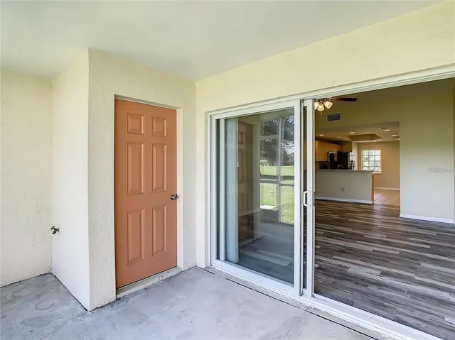 a view of a hallway with wooden floor and entryway