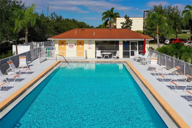 a view of house with swimming pool yard and outdoor seating
