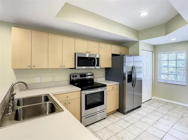 a kitchen with a sink a microwave and refrigerator