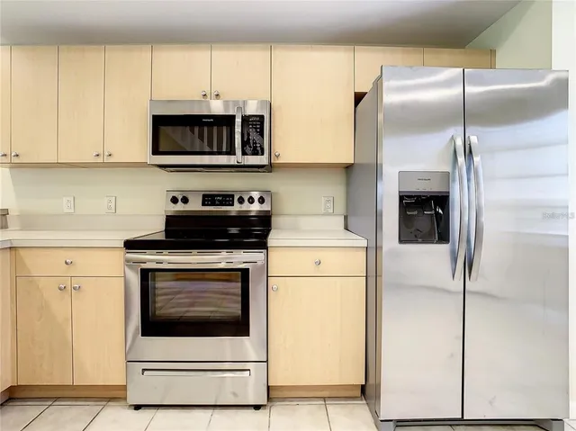 a kitchen with stainless steel appliances a stove a microwave and a refrigerator