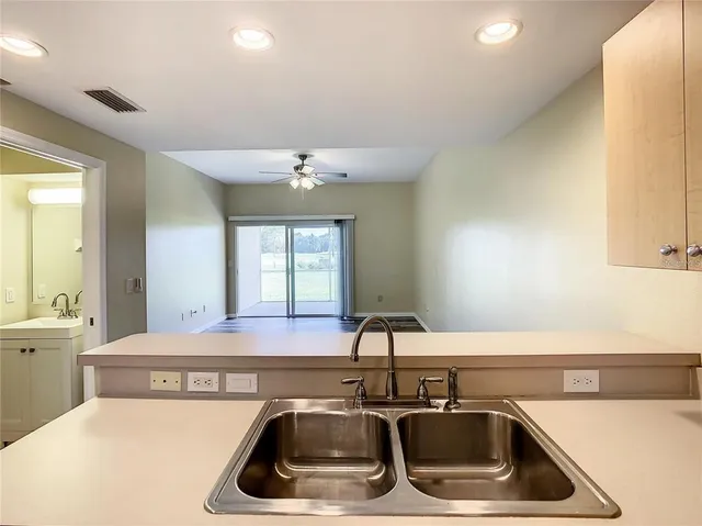 a kitchen with a sink a counter top space and cabinets