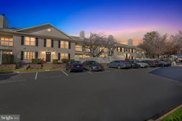 a city street lined with parked cars and buildings