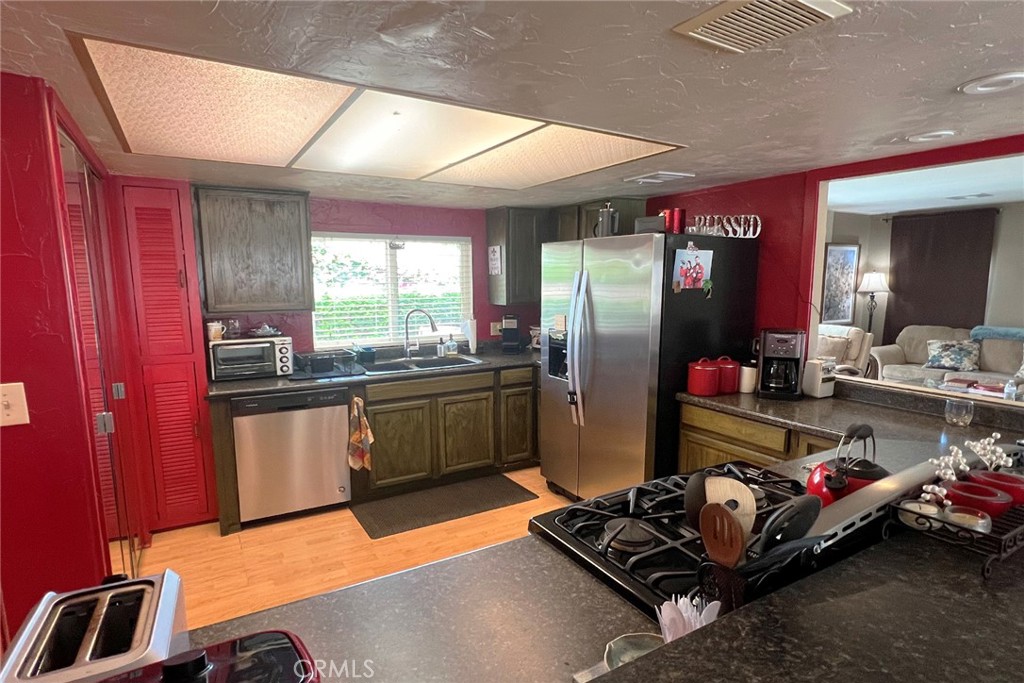 119 Del Mar Rancho Mirage, CA 92270 - Photo 17 of 40 a kitchen with sink refrigerator and window