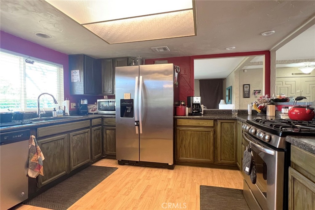 119 Del Mar Rancho Mirage, CA 92270 - Photo 20 of 40 a kitchen with stainless steel appliances granite countertop a refrigerator and a sink