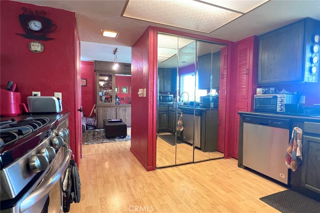 119 Del Mar Rancho Mirage, CA 92270 - Photo 21 of 40 a kitchen with stainless steel appliances kitchen island granite countertop a stove a refrigerator and a microwave