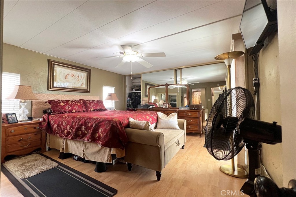 119 Del Mar Rancho Mirage, CA 92270 - Photo 23 of 40 a spacious bedroom with a bed a couch and a chandelier