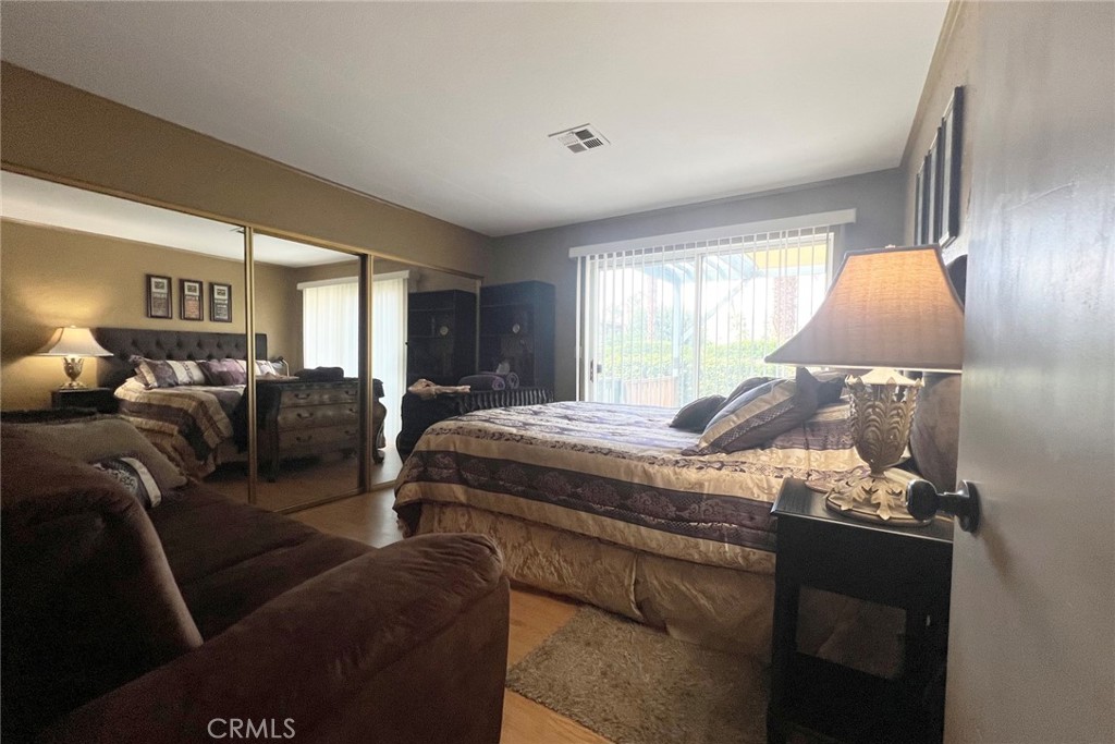 119 Del Mar Rancho Mirage, CA 92270 - Photo 26 of 40 a bedroom with furniture and a large window