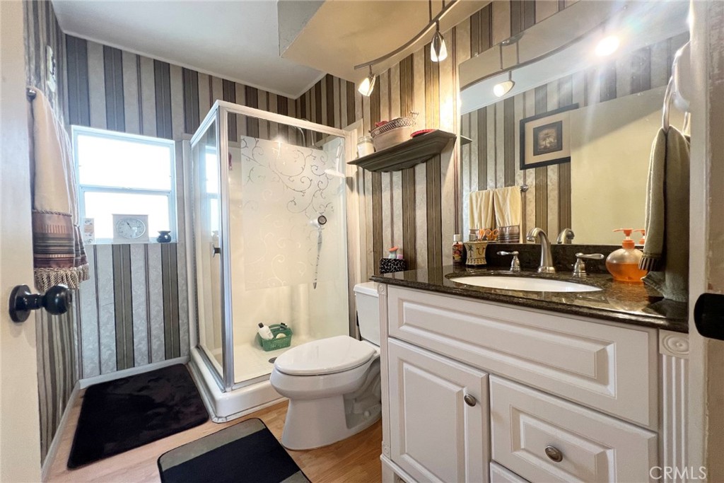 119 Del Mar Rancho Mirage, CA 92270 - Photo 27 of 40 a bathroom with a sink a toilet a mirror and shower