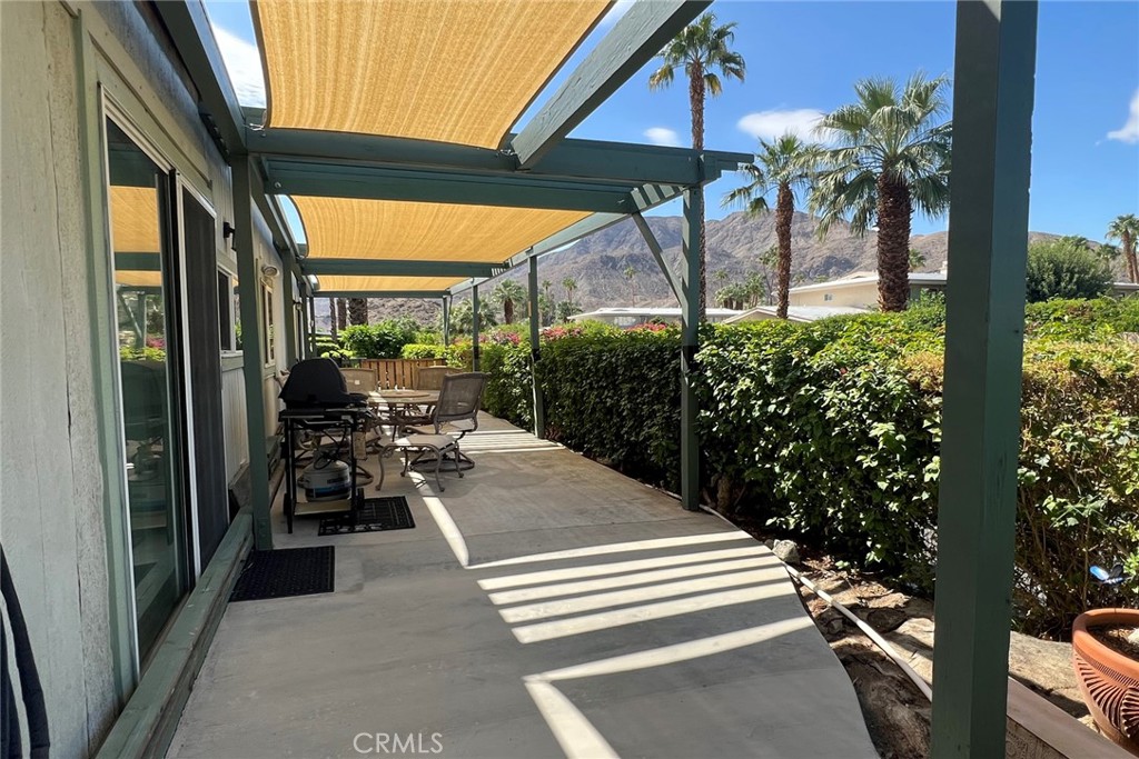 119 Del Mar Rancho Mirage, CA 92270 - Photo 28 of 40 a view of a patio with table and chairs potted plants