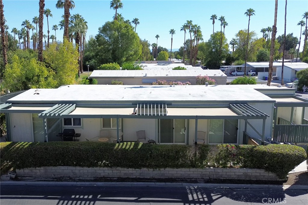 119 Del Mar Rancho Mirage, CA 92270 - Photo 9 of 40 a view of a house with a yard and potted plants