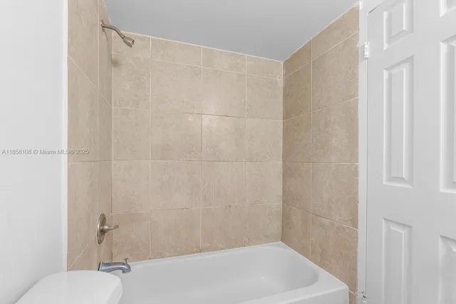 a bathroom with a bathtub and a toilet