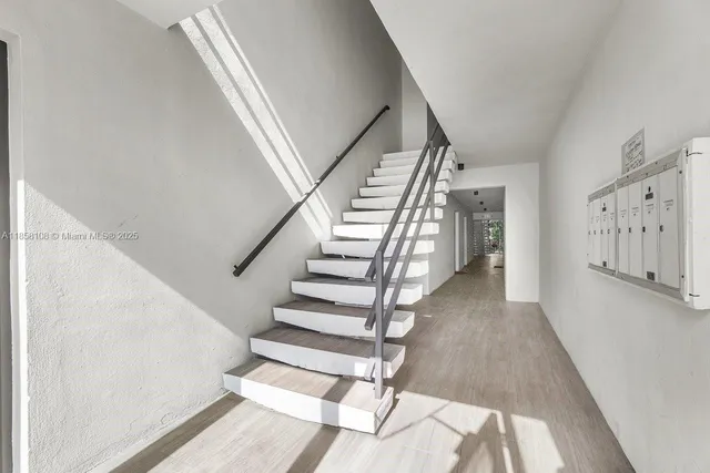 a view of entryway and hall with wooden floor