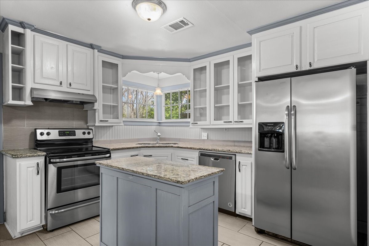 1107 Washington Street Brenham, TX 77833 - Photo 11 of 19 a kitchen with a stove sink and refrigerator
