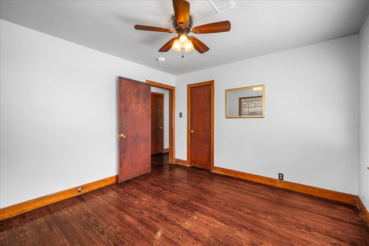 1107 Washington Street Brenham, TX 77833 - Photo 13 of 19 wooden floor in an empty room with a window