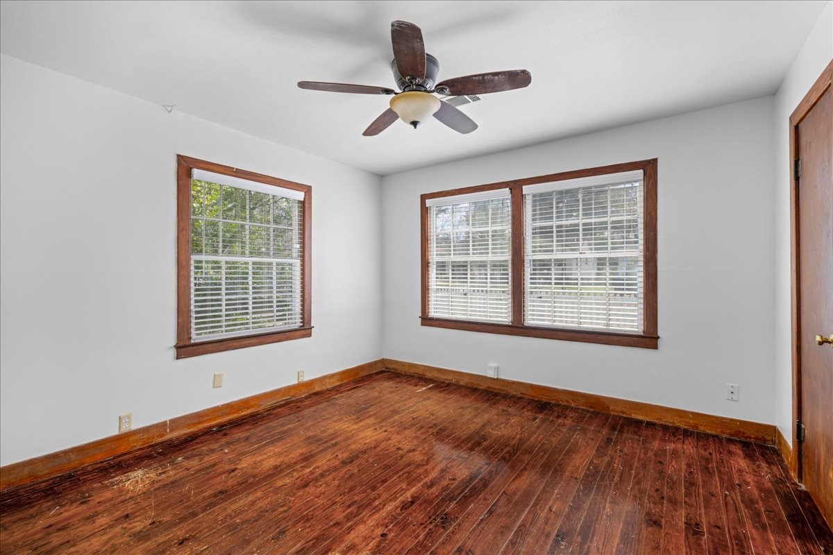 1107 Washington Street Brenham, TX 77833 - Photo 17 of 19 a view of an empty room with wooden floor and a window