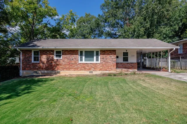 a view of a house with a yard patio and a garden
